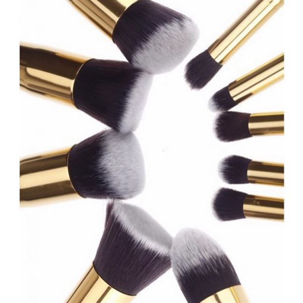 The PRO Makeup Brush Set Black/Gold features 10 premium kabuki and precision brushes with gold handles and black-and-white bristles, artfully arranged in a circle on a white background.